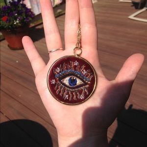 Evil eye embroidered pendant